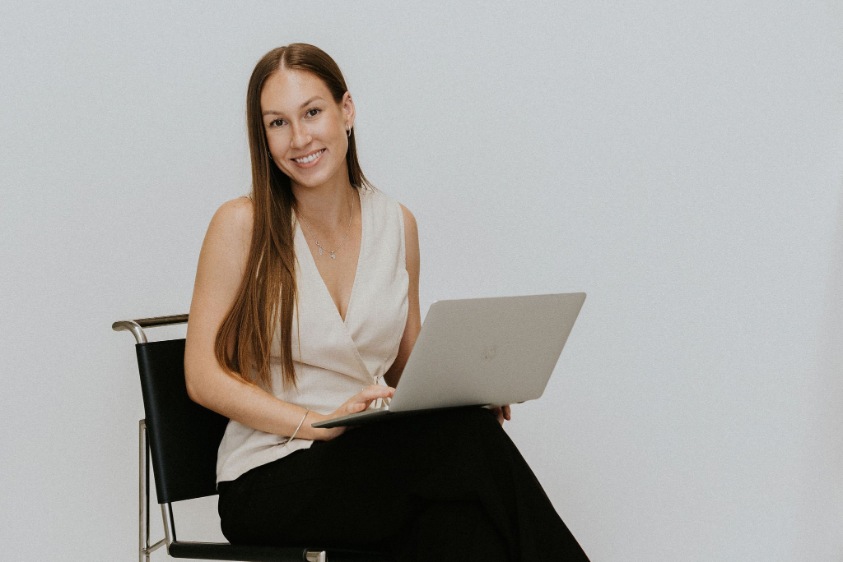 Long brunette haired marketing professional smiling at camera