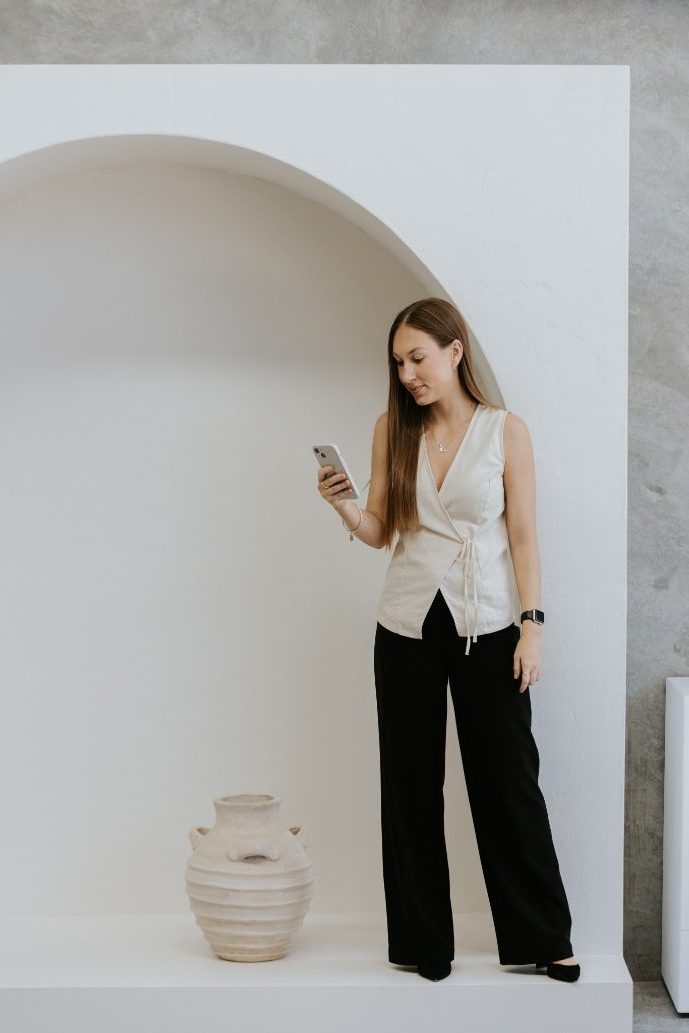 Long haired brunette marketing woman looking at her phone