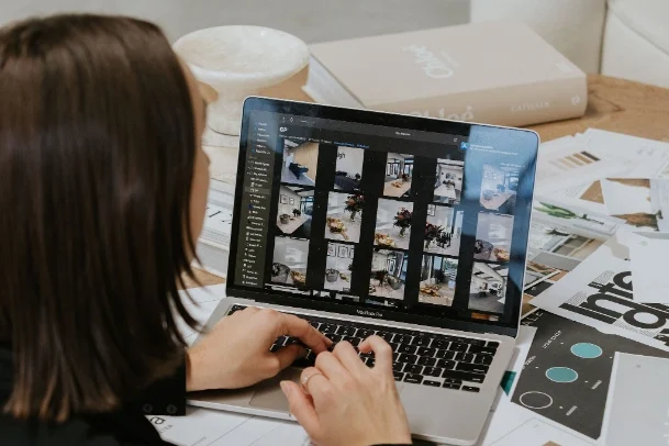 Close up of brunette woman looking at photo gallery on laptop