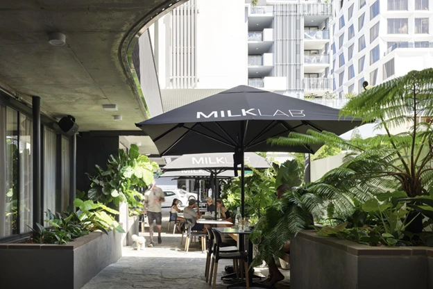 Milk Lab printed on black umbrella outside of brisbane cafe