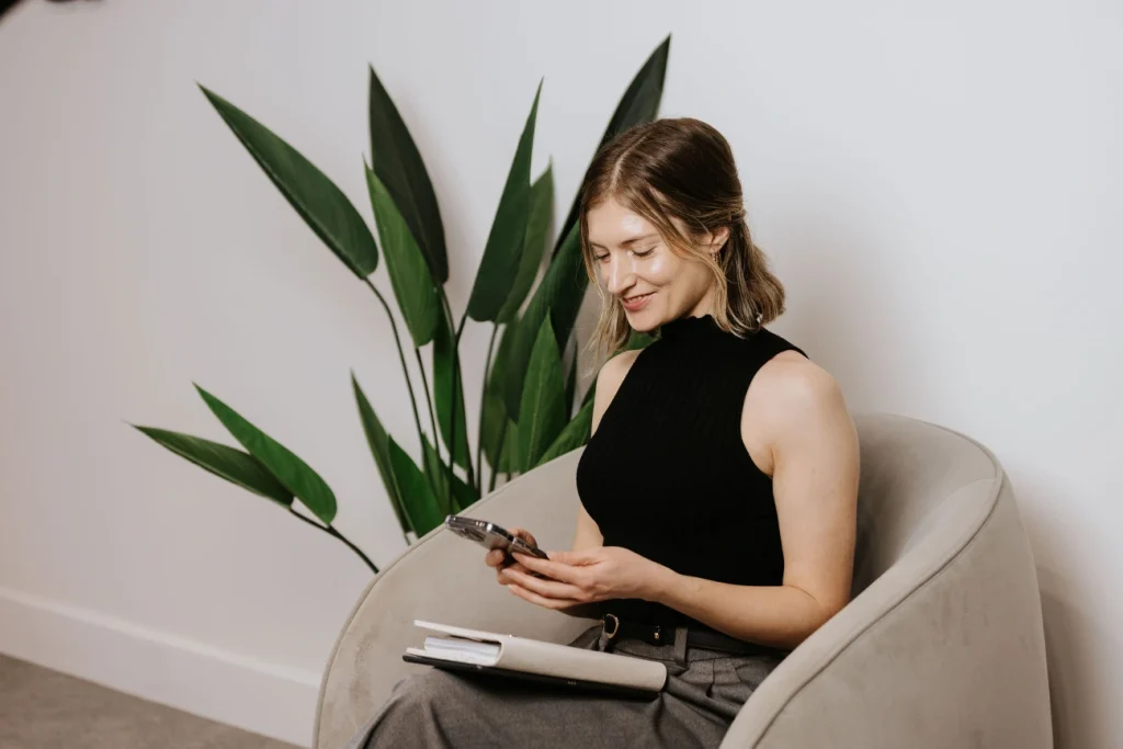 short haired brunette marketing professional looking at her phone